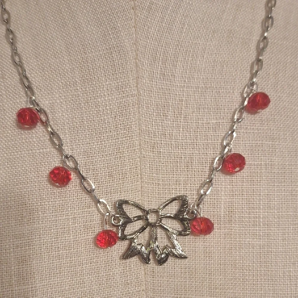 Elegant Silver and Red Bow Necklace